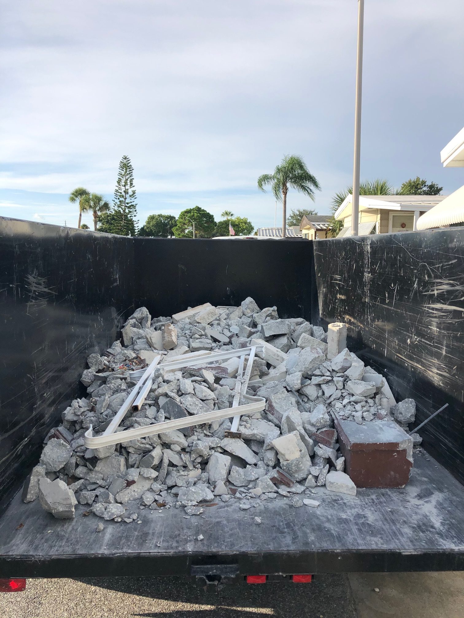 Concrete debris loaded in a dumpster for removal in Tampa Bay