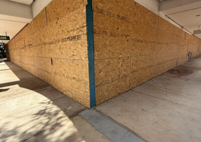 Exterior-grade plywood professionally installed to secure a vacant commercial building.