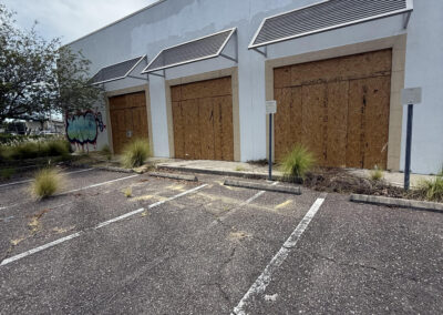 Completed commercial board-up project protecting a vacant retail property.
